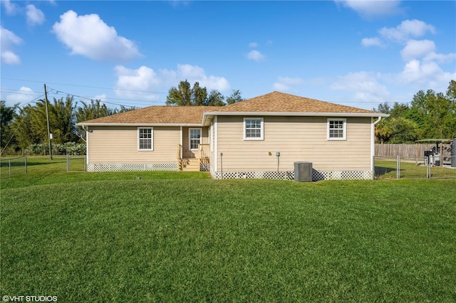 back of house with a yard and central AC unit