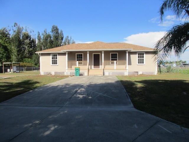 ranch-style house with a porch and a front lawn