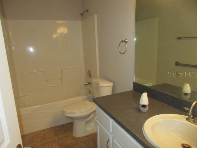 full bath featuring toilet, bathtub / shower combination, and vanity