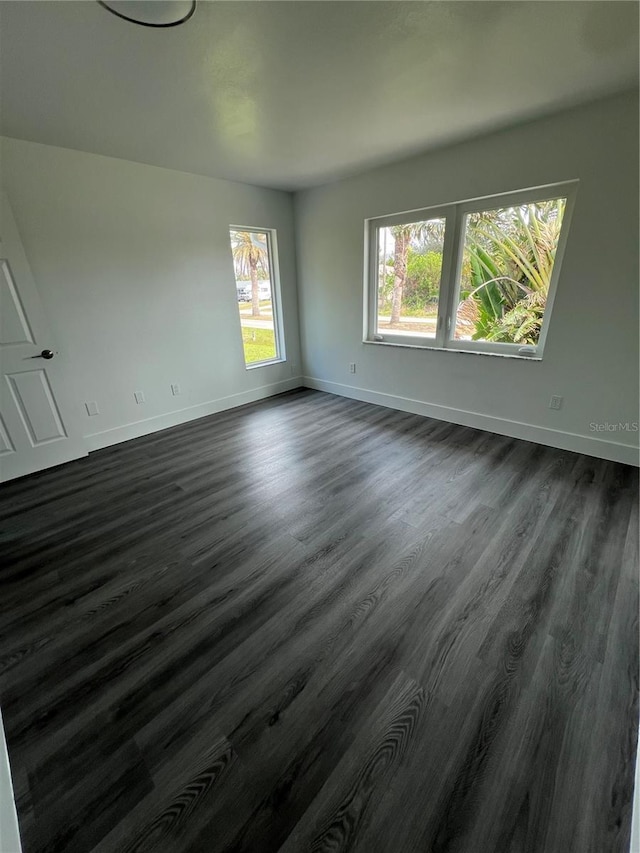 empty room with dark wood-type flooring