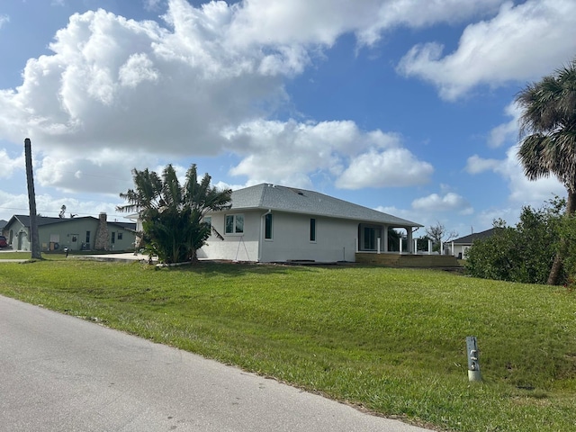 view of side of home featuring a lawn