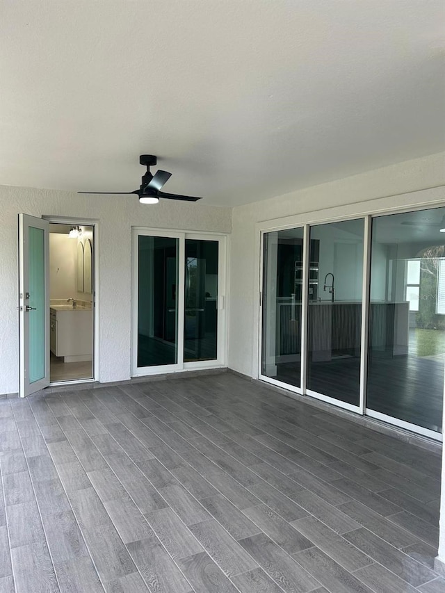 interior space featuring ceiling fan and a wooden deck