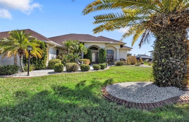 mediterranean / spanish-style house with a front yard