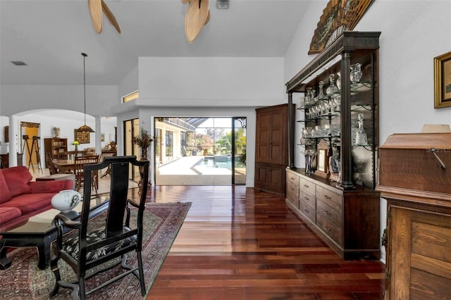 living room featuring ceiling fan and dark hardwood / wood-style flooring