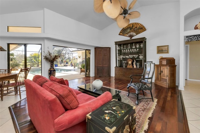 living room featuring high vaulted ceiling, hardwood / wood-style floors, and ceiling fan