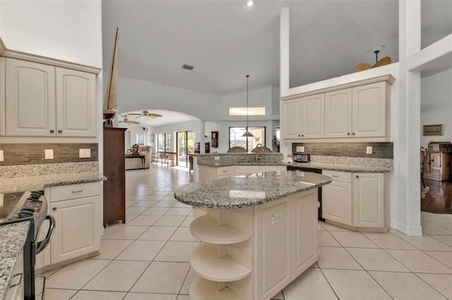 kitchen featuring decorative light fixtures, light stone countertops, stainless steel electric stove, and kitchen peninsula