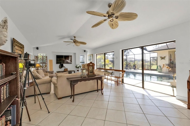 living room with ceiling fan, light tile patterned floors, and lofted ceiling