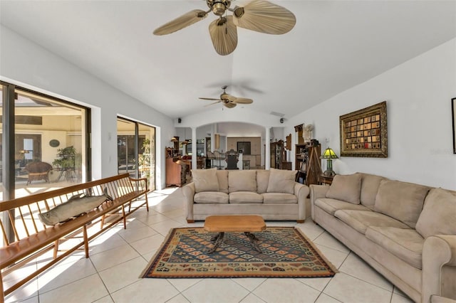 living room featuring vaulted ceiling, ceiling fan, and light tile patterned floors