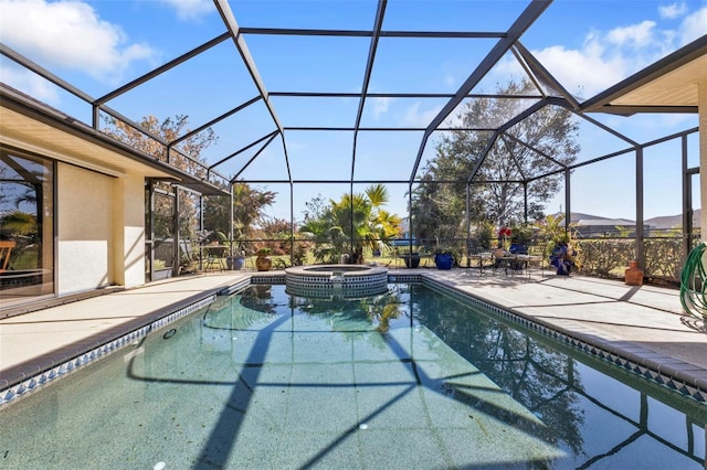 view of swimming pool with an in ground hot tub, a lanai, and a patio