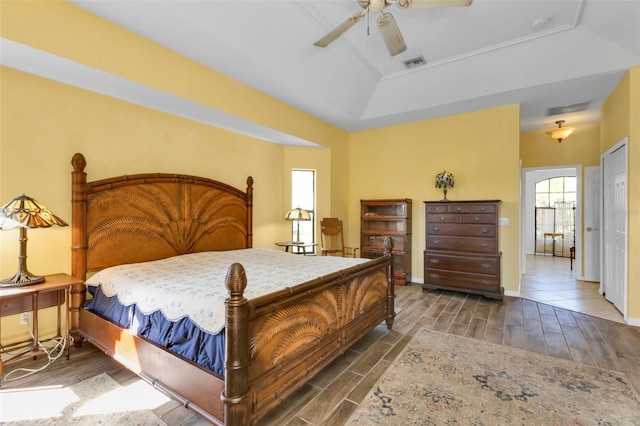 bedroom with ceiling fan and a raised ceiling