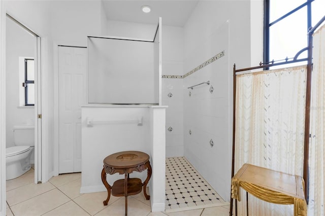 bathroom with toilet and tile patterned floors