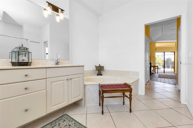 bathroom featuring a tub, tile patterned floors, and vanity