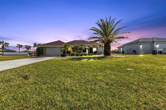 ranch-style house featuring a lawn and a garage