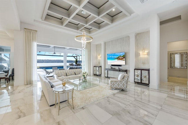 living room with beamed ceiling, a chandelier, a towering ceiling, and coffered ceiling