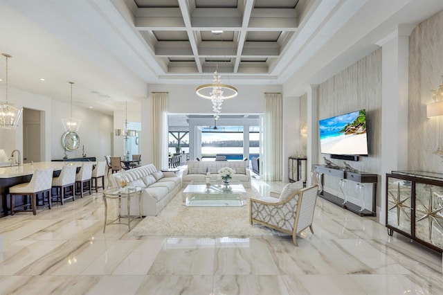 living room with a towering ceiling, coffered ceiling, sink, beam ceiling, and an inviting chandelier