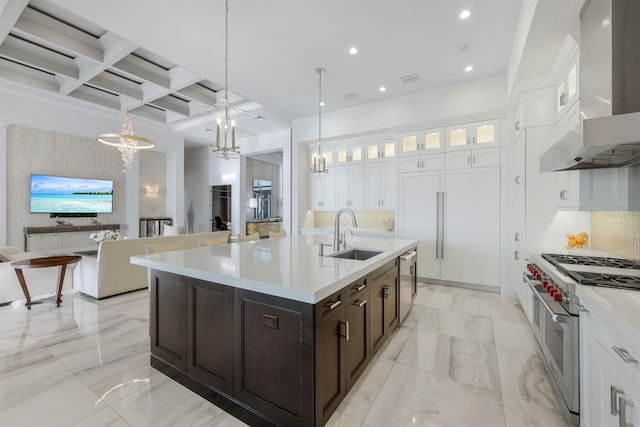 kitchen with coffered ceiling, white cabinets, sink, wall chimney exhaust hood, and appliances with stainless steel finishes