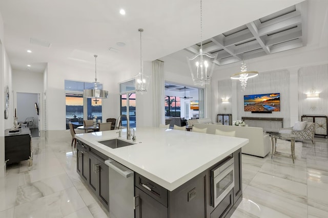 kitchen featuring coffered ceiling, stainless steel appliances, sink, beam ceiling, and decorative light fixtures