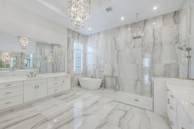 bathroom featuring a notable chandelier, separate shower and tub, plenty of natural light, and tile walls