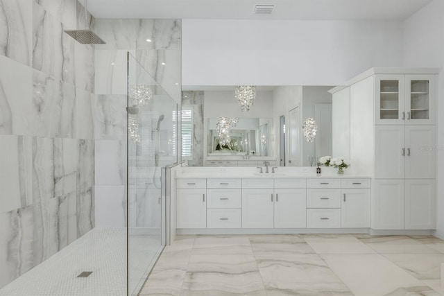 bathroom featuring vanity and tiled shower