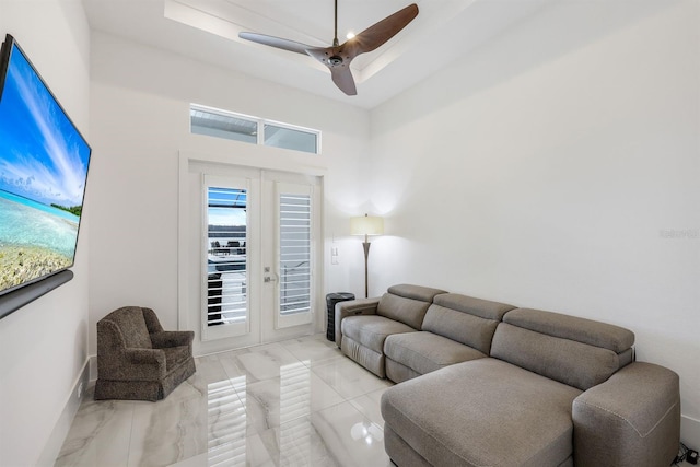 living room with ceiling fan and french doors