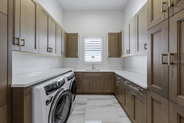 laundry room featuring cabinets, sink, and washing machine and dryer