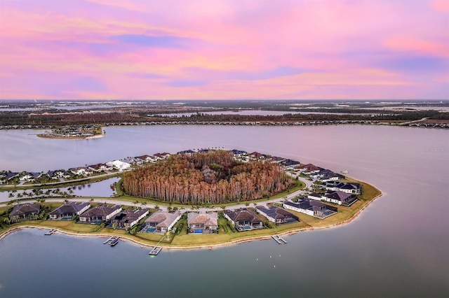 aerial view at dusk with a water view