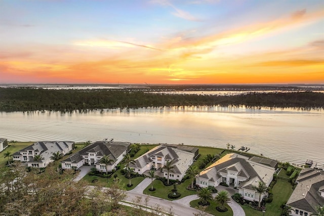 aerial view at dusk with a water view