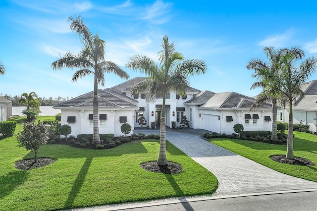 view of front of house featuring a garage and a front yard