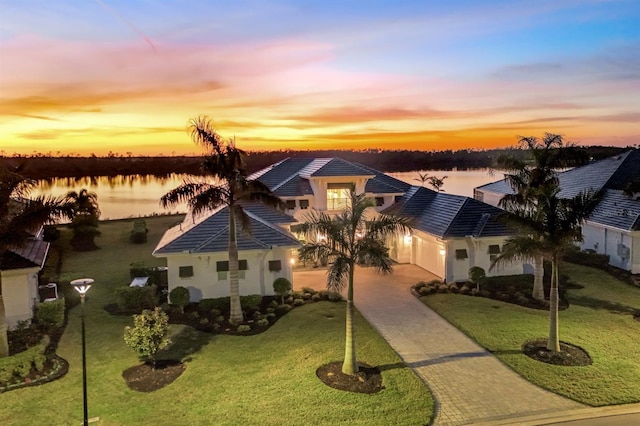 view of front of property featuring a water view and a yard