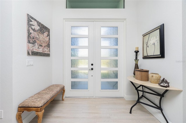 doorway to outside featuring french doors and light wood-type flooring