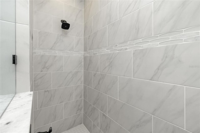 bathroom with tiled shower