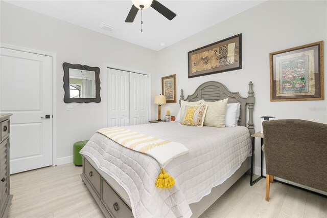 bedroom featuring ceiling fan, a closet, and light hardwood / wood-style flooring