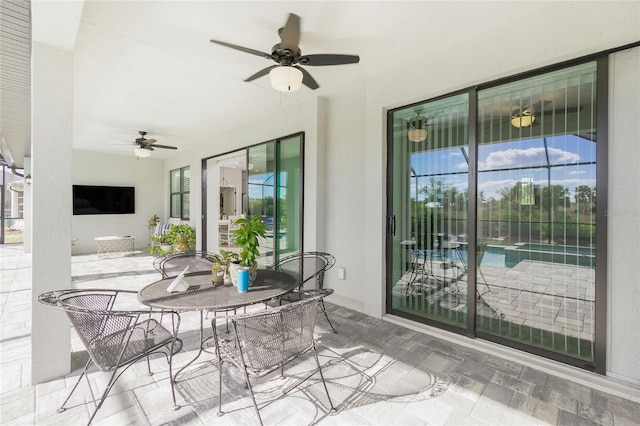 sunroom / solarium featuring a wealth of natural light and ceiling fan