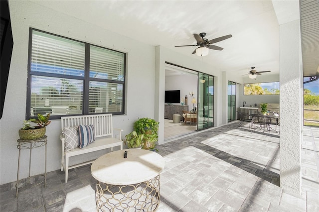 view of patio featuring ceiling fan