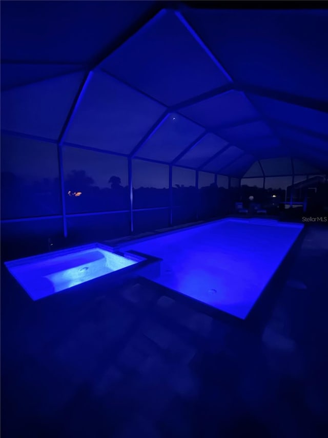 view of swimming pool with an in ground hot tub