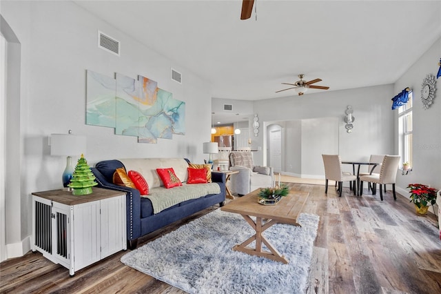 living room with hardwood / wood-style floors and ceiling fan