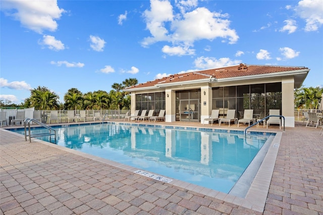 view of pool with a patio area and a sunroom