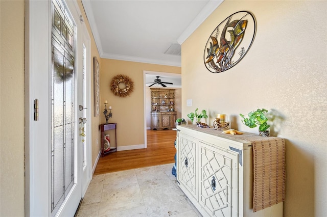 foyer with light hardwood / wood-style flooring, ceiling fan, and crown molding