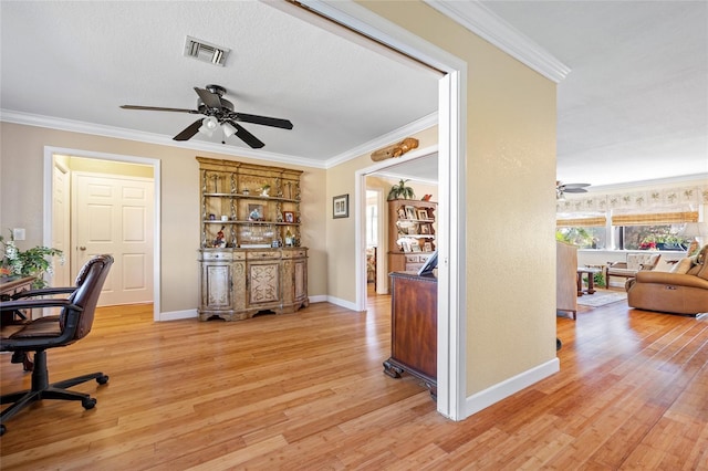 office featuring a textured ceiling, ceiling fan, crown molding, and light hardwood / wood-style flooring