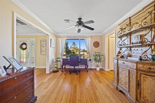 home office featuring crown molding, ceiling fan, a textured ceiling, and light wood-type flooring