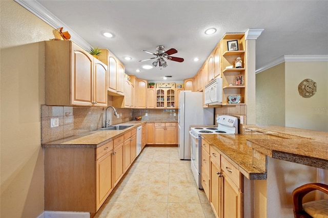 kitchen with white appliances, crown molding, sink, tasteful backsplash, and kitchen peninsula