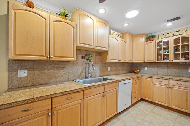 kitchen featuring dishwasher, light brown cabinets, and sink