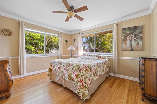 bedroom featuring multiple windows, ceiling fan, and light hardwood / wood-style flooring