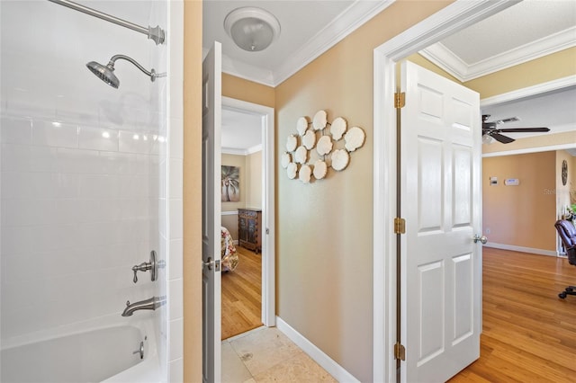 bathroom featuring hardwood / wood-style flooring, ceiling fan, crown molding, and bathtub / shower combination