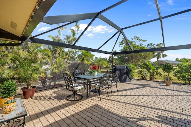 view of patio featuring a lanai and a grill