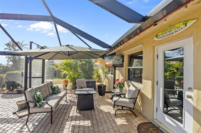 view of patio with an outdoor hangout area and glass enclosure