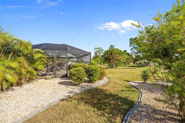 view of yard with glass enclosure