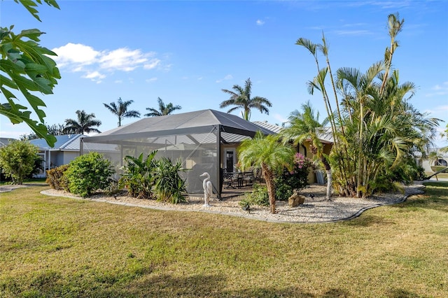 exterior space with a lawn and glass enclosure