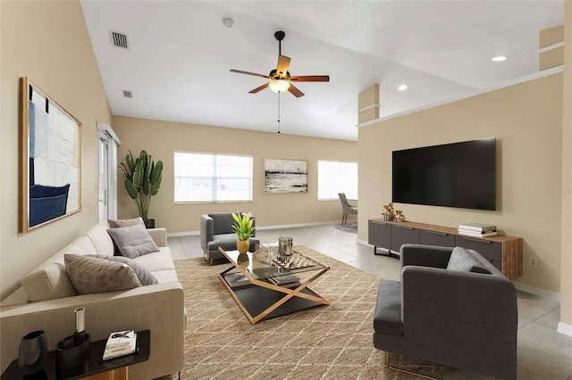 tiled living room featuring ceiling fan and high vaulted ceiling