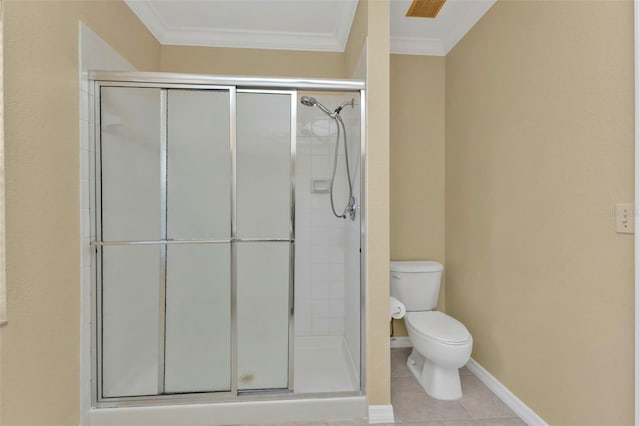 bathroom with tile patterned floors, a shower with shower door, toilet, and ornamental molding